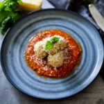 Chicken Meatballs in tomato sauce on a blue plate