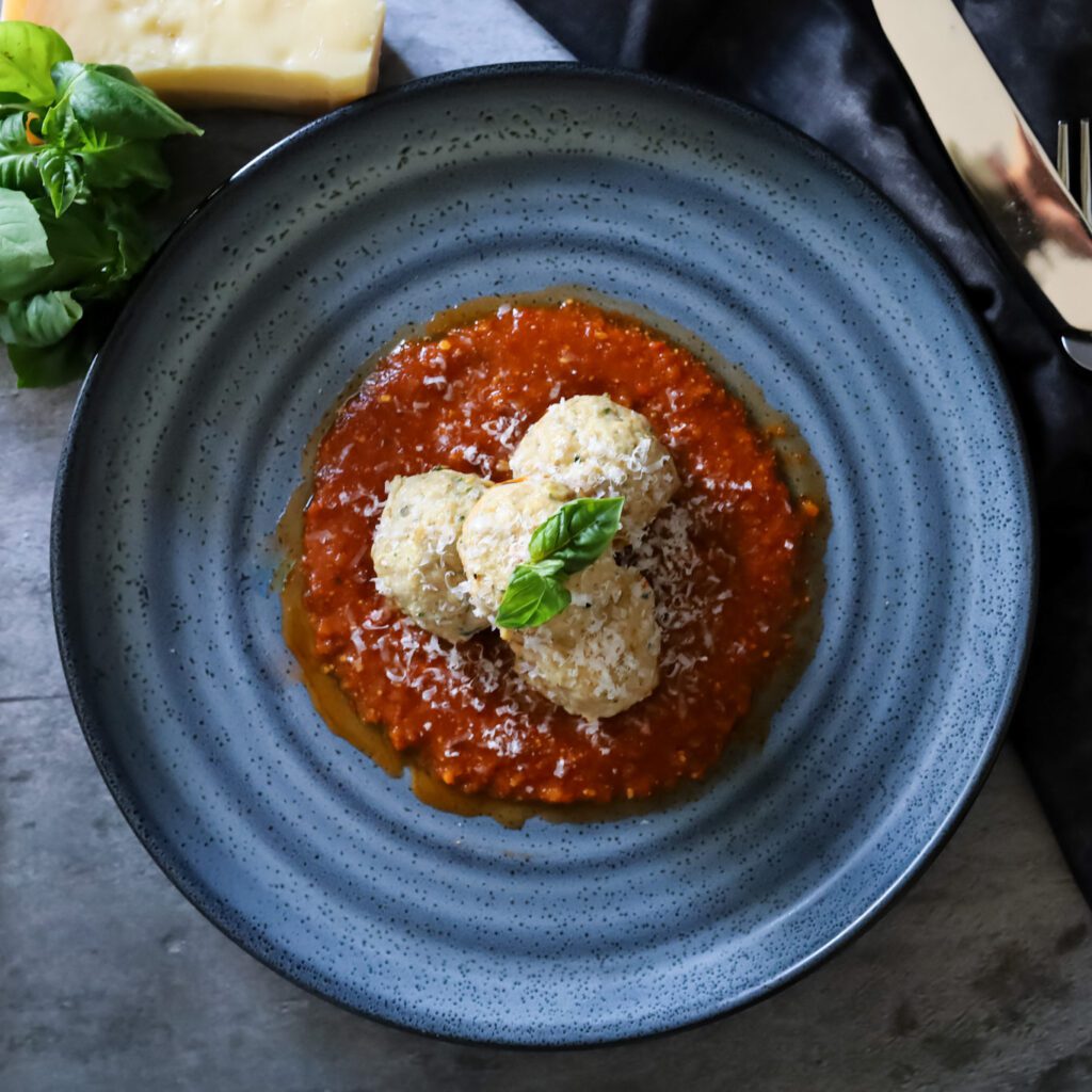 Chicken Meatballs on tomato sauce on a blue plate